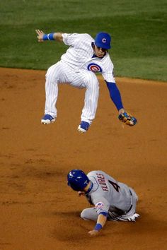 two baseball players collide as one catches the ball