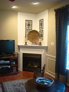 a living room with a fire place and television on the fireplace mantel in front of it