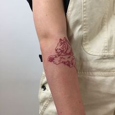 a woman's arm with a tattoo on it that has a lion on it