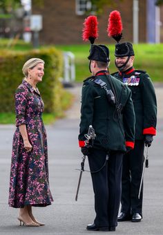 the queen and prince are standing next to each other