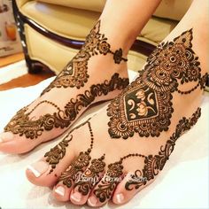 the feet are decorated with henna designs