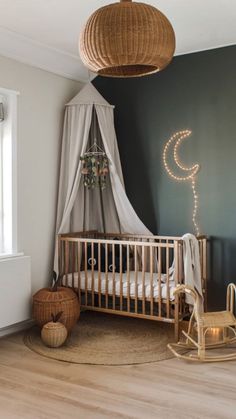 a baby's room with a crib, rocking chair and lights on the wall