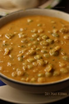 a white bowl filled with soup on top of a blue and white plate