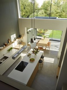 an aerial view of a kitchen and dining room from the living room to the backyard