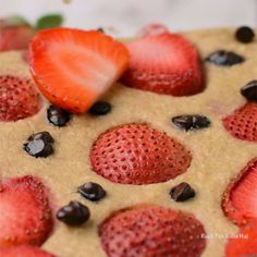 some strawberries and chocolate chips on top of a cookie