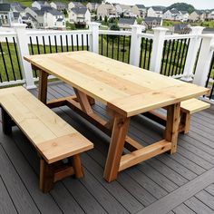 a wooden table and bench on a deck