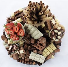 a platter filled with assorted chocolates and strawberries