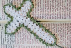 a cross stitched onto the side of a book