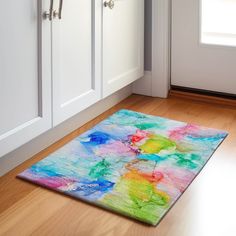 a colorful area rug in the middle of a kitchen