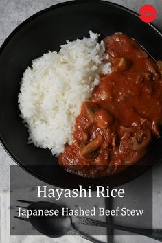 rice and meat in a bowl with chopsticks on the side