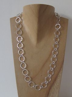 "Handmade Sterling silver circles necklace. A contemporary solid silver necklace, inspired by Scandinavian style, has a hammered texture which catches the light.   The silver circle links are approx. 1.5cm in diameter and the necklace is 18\" long but as it is all handmade it can be made in any specific length to suit. This necklace is a timeless, elegant design which compliments either a casual or dressy style of outfit. The silver chain necklace is hallmarked with my unique maker's mark by the Jump Ring Jewelry, Contemporary Scandinavian, Handmade Silver Jewellery, Handmade Chain, Wire Jewelry Designs, Silver Jewelry Design, Silver Chains, Silver Circle, Handmade Jewelry Designs