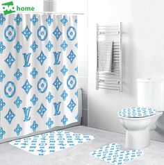 a white toilet sitting next to a blue and white shower curtain on top of a bathroom floor