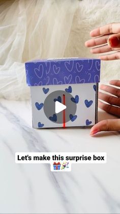 someone is holding a box with hearts on it and the text let's make this surprise box