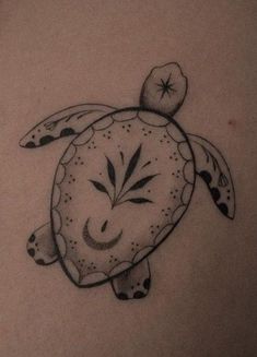 a black and white photo of a turtle tattoo