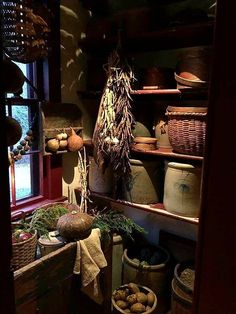 an old fashioned kitchen with pots and pans on the shelf next to each other