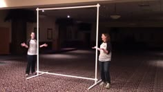 two women are standing in an empty room