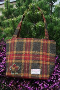 A beautifully spacious Scottish Harris tweed® tote bag with square corners and two shoulder straps which fits comfortably under or over the arm. The size will accommodate an A4 file or iPad. A practical yet stylish size for any woman. Adorned with a felt and tweed applique flower. Tweed is an incredibly durable yet soft fabric, made by crofters to withstand the elements in the North of Scotland. It has a zip across the top to provide security and has a zipped internal pocket too.  Custom request Rectangular Tweed Bag For Fall, Rectangular Tweed Bags For Fall, Fall Tweed Shoulder Bag, Rectangular Shape, Rectangular Tweed Shoulder Bag For Fall, Fall Rectangular Tweed Shoulder Bag, Wool Rectangular Bag For Fall, Rectangular Wool Bag For Fall, Rectangular Tweed Bags For Daily Use, Rectangular Tweed Bag For Daily Use