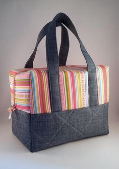 an instagramted photo of a handbag made from denim and fabric with colorful stripes