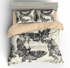 an image of a bed with butterflies and flowers on the comforter cover, along with two pillows