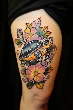 a woman's thigh with a turtle and flowers on it