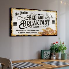 an old fashioned sign hangs on the wall above a dining room table