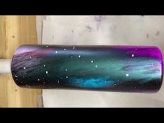 a close up of a purple and green tube on a white pipe with stars in the sky