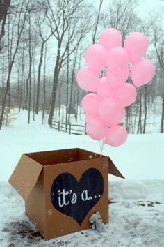 a box with balloons in the shape of a heart and it's a boy