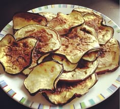 a white plate topped with sliced up eggplant