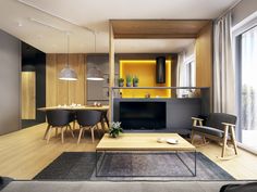 a living room filled with furniture and a flat screen tv on top of a wooden table