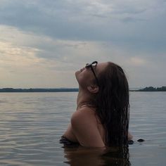 a woman floating in the water with her eyes closed