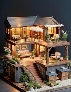 a doll house with lots of furniture and plants on the front porch, including an umbrella