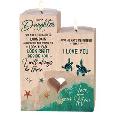 two wooden candles with the words to my daughter and i love you on them