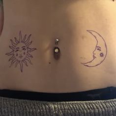 a woman's stomach with sun and moon tattoos on it