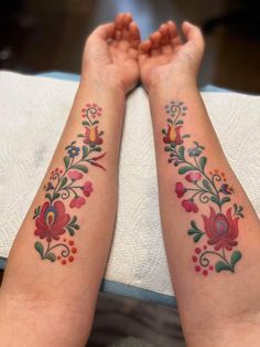 two women with matching tattoos on their arms