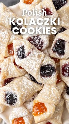 polish kolaczki cookies with jelly and powdered sugar on top in a white bowl