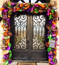 the front door is decorated with colorful ribbons and decorations for halloween time, as well as an iron gate