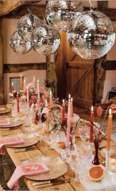 a long table with plates and candles on it