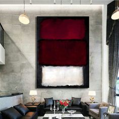 a living room filled with furniture and a painting on the wall