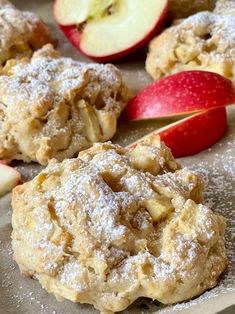 apple pie cookies with powdered sugar and an apple on the side, ready to be eaten