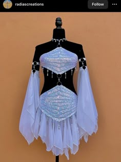 a mannequin is dressed in white and blue with sequins on it