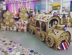 there is a train made out of cardboard and decorated with stickers on the floor