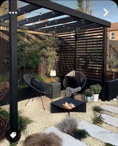 an outdoor patio with black furniture and plants