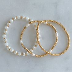 This holiday gift set features my favorite three stacking bracelets that instantly elevates any outfit. You can’t go wrong with gold and pearls to add a sparkle to your wardrobe! This set includes our most popular white sands bracelet, our dainty wanderlust beaded bracelet in plain gold, and our most recent favorite boardwalk beaded bracelet with gold beads and rice pearls. Please refer to the size guide for your bracelet size. Pearl Bracelet Stack, Gold And Pearls, Dainty Chain Necklace, Rice Pearls, Stacking Bracelets, Holiday Gift Sets, Gem Ring, Wire Wrapped Rings, Glass Beaded Bracelets