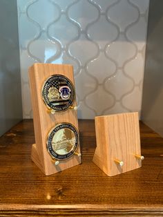 two wooden plaques sitting on top of a table next to each other with an american flag