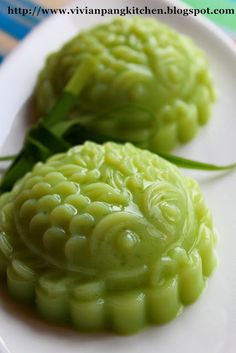 two green food items on a white plate