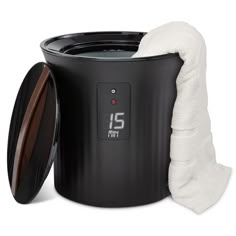 a black trash can with a white towel next to it's lid and cover