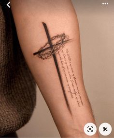 a person with a cross tattoo on their arm