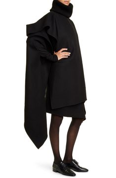 An oversized asymmetric silhouette distinguishes this voluminous poncho crafted in Italy of luxurious double-face cashmere. 36" front length; 56 1/2" back length Bateau neck 100% cashmere Dry clean Made in Italy Designer Clothing Luxury Oversized Black Poncho, Luxury Cashmere Chic Poncho, Luxury Black Poncho, Black Wool Cape Poncho, Oversized Long Sleeve Cashmere Poncho, Cashmere Poncho, Bateau Neck, Double Face, The Row