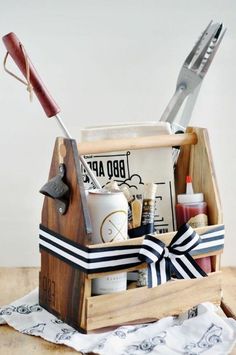 a wooden box filled with different items on top of a table