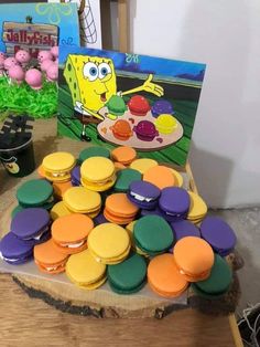 spongebob macaroons are sitting on a table next to an open book